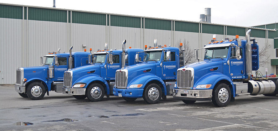 Blue Dimension Fabricators trucks parked in their lot.