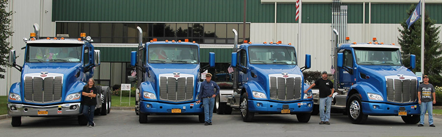Dimension Fleet vehicles and their drivers pose together.