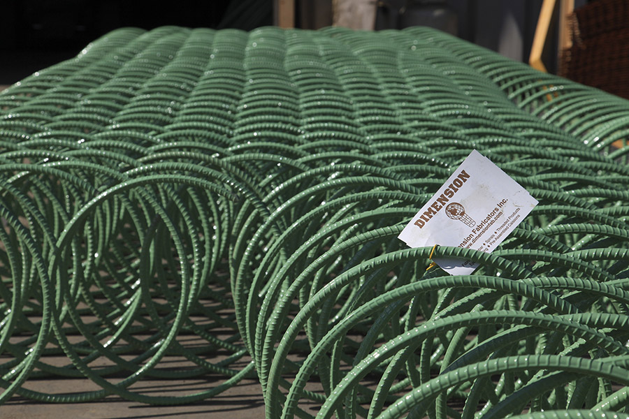 Epoxy coated rebar spirals in a row.