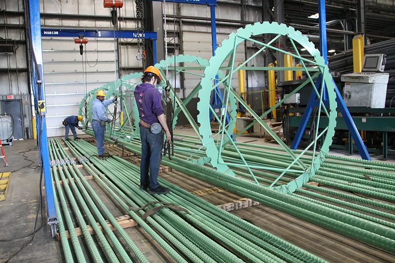Workers fabricate Epoxy-coated cage-support system
